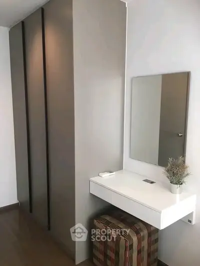 Modern bedroom with sleek wardrobe and stylish vanity area