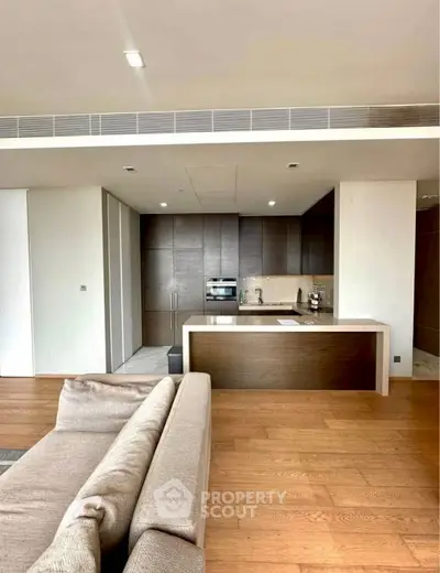 Modern open kitchen with sleek cabinetry and cozy living area