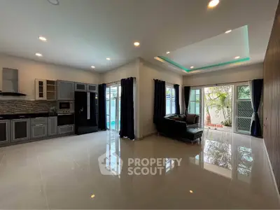 Spacious modern living room with open kitchen and large windows