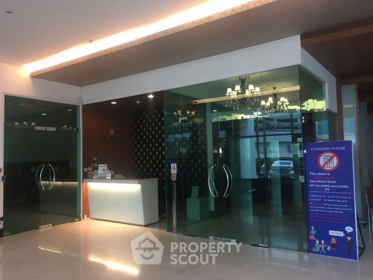Modern building entrance with glass doors and sleek reception area.