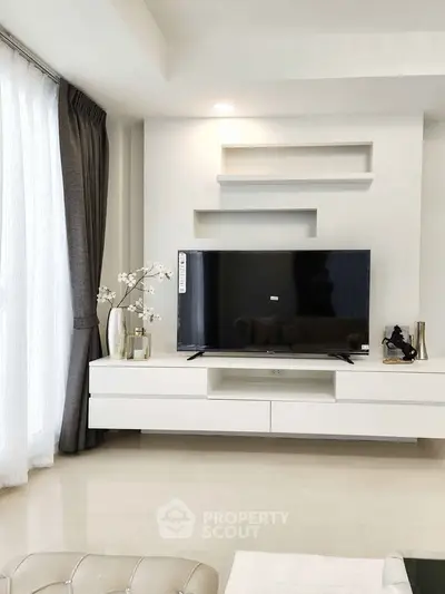 Modern living room with sleek TV unit and elegant decor