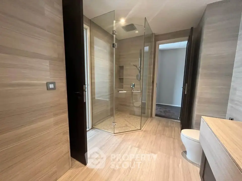Luxurious modern bathroom with glass shower and elegant wood paneling