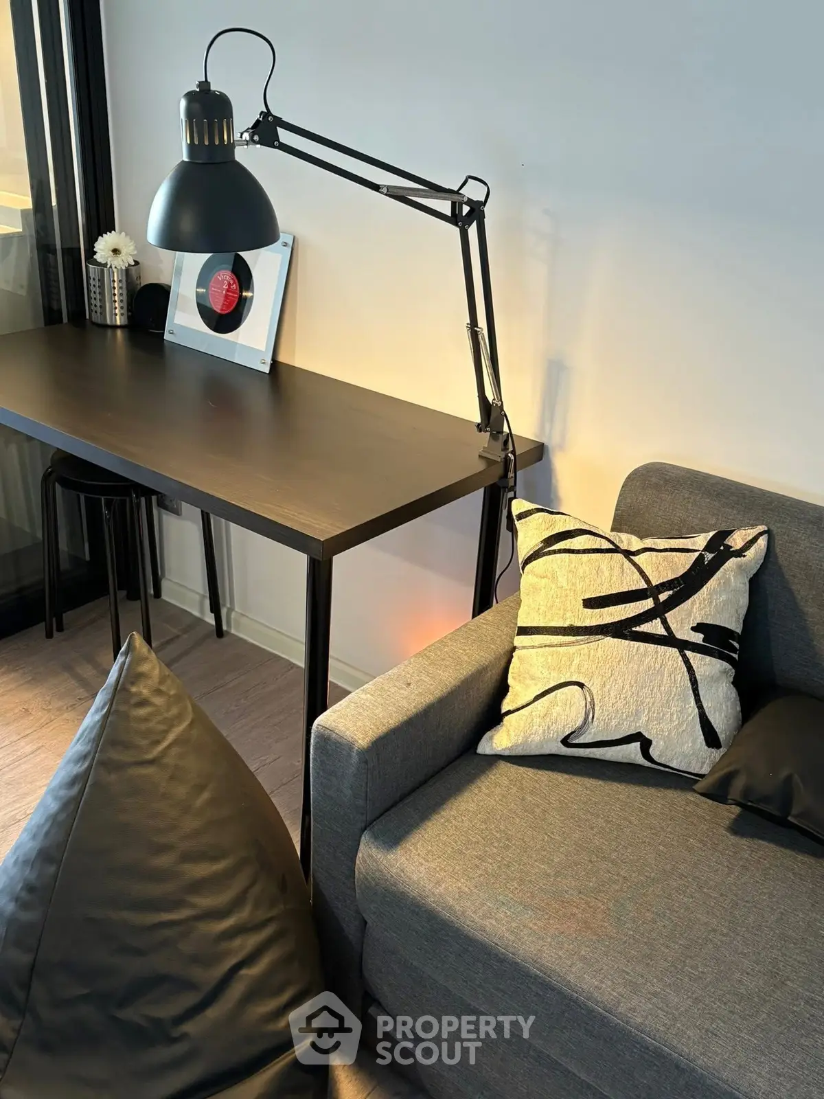 Modern living room with stylish decor and cozy seating area, perfect for relaxation and work-from-home setup.