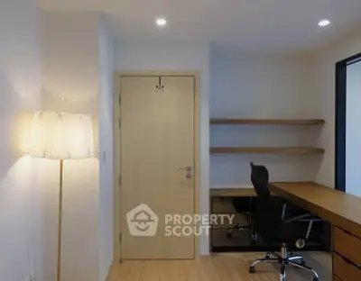 Modern study room with sleek desk, ergonomic chair, and ambient lighting.