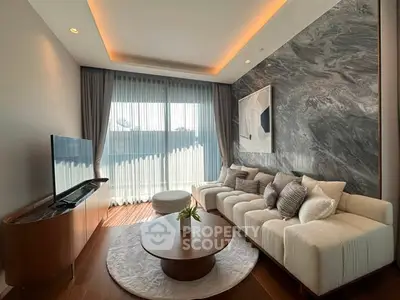 Luxurious living room with modern decor, large sofa, and natural light from floor-to-ceiling windows.