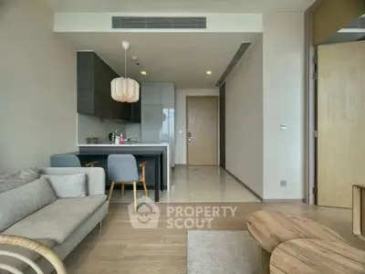 Modern open-plan living room with stylish kitchen and cozy seating area.