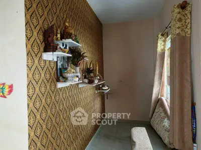 Charming living room with elegant wallpaper and cozy seating area, perfect for relaxation.
