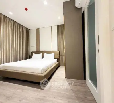 Modern bedroom with sleek design and cozy ambiance, featuring elegant furnishings and soft lighting.