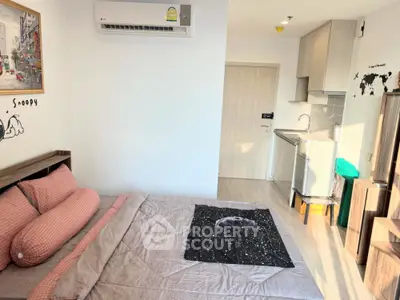 Cozy bedroom with compact kitchen in modern apartment