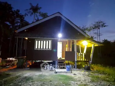 Charming rustic cabin with warm lighting in a serene natural setting, perfect for a tranquil retreat.