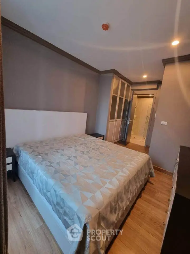 Cozy bedroom with modern decor and ample natural light, featuring a spacious bed and stylish wardrobe.