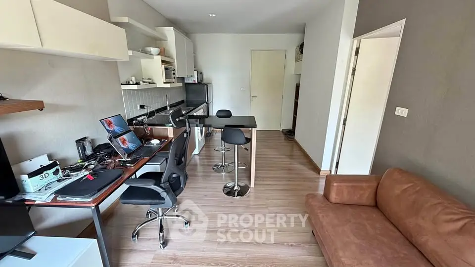 Modern living room with open kitchen layout and stylish furniture