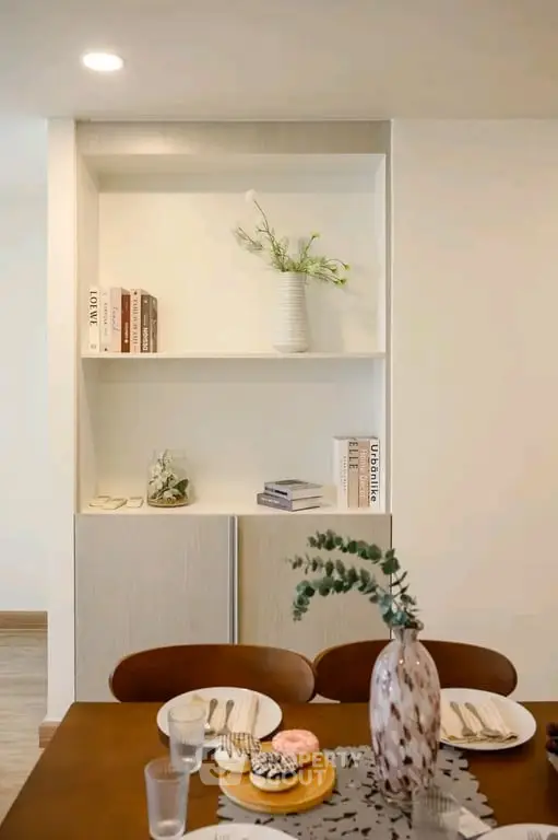 Stylish dining area with elegant table setting and modern built-in shelving, perfect for contemporary living.
