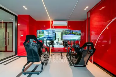 Luxury home gaming room with racing simulators and vibrant red decor
