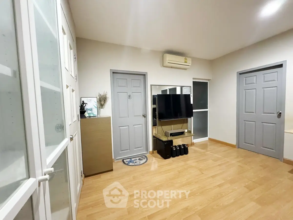 Spacious living room with modern decor and wooden flooring