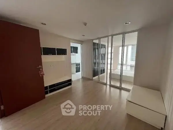 Modern apartment interior with glass partition and sleek wooden flooring