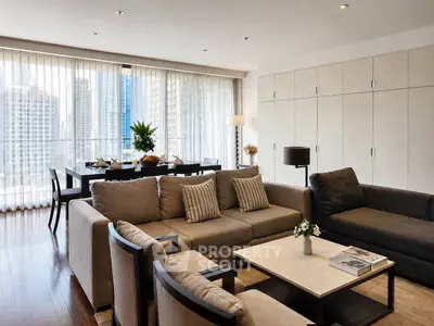 Spacious modern living room with large windows and city view, featuring elegant furniture and stylish decor.