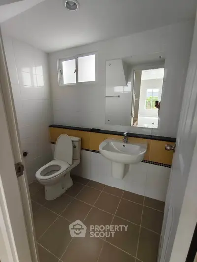 Modern bathroom with sleek fixtures and natural light, perfect for a contemporary home.
