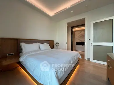 Luxurious bedroom with modern lighting and elegant decor, featuring a cozy bed and stylish wooden accents.