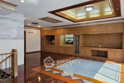 Spacious living room with wooden flooring and built-in cabinets