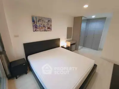 Spacious modern bedroom with sleek furniture and ample natural light