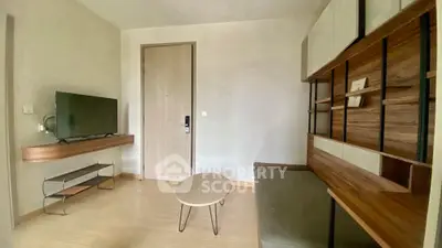 Modern living room with sleek furniture and wall-mounted TV