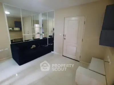Modern living room with sleek design and mirrored wall, perfect for urban living.