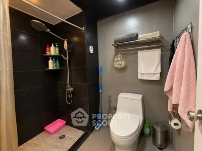 Modern bathroom with sleek black tiles and contemporary fixtures