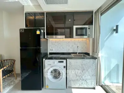 Modern compact kitchen with sleek appliances and stylish marble countertops.