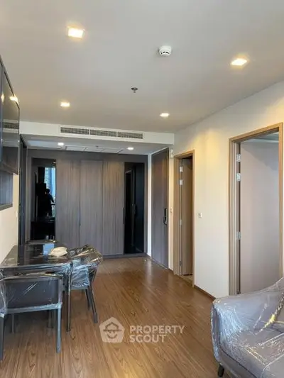 Modern living room with wooden flooring and stylish furniture in a contemporary apartment.