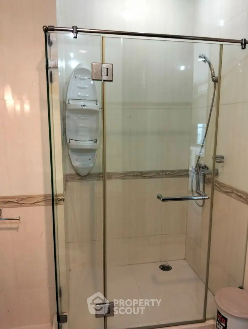Modern bathroom with glass shower enclosure and sleek fixtures