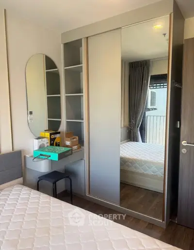 Modern bedroom with mirrored wardrobe and cozy decor