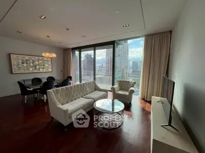 Luxurious living room with stunning city view, elegant furniture, and floor-to-ceiling windows in modern apartment.