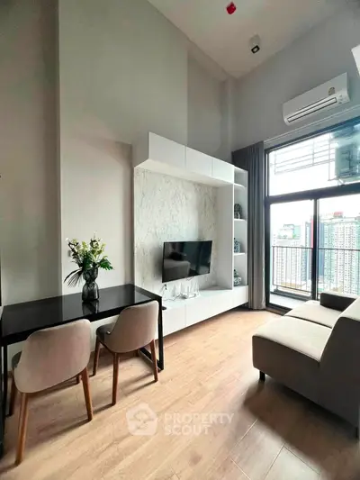 Modern living room with large windows and city view, featuring stylish furniture and elegant decor.