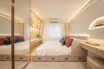 Modern bedroom with mirrored wardrobe and elegant lighting