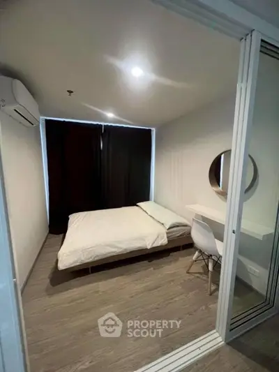 Modern bedroom with minimalist design, featuring a cozy bed and sleek furniture, perfect for urban living.