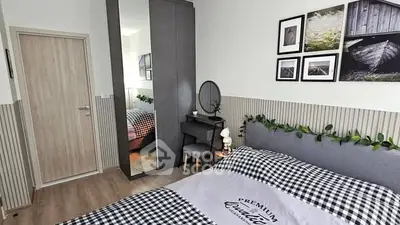 Charming bedroom with modern decor, featuring a cozy bed, stylish mirror, and elegant wall art.