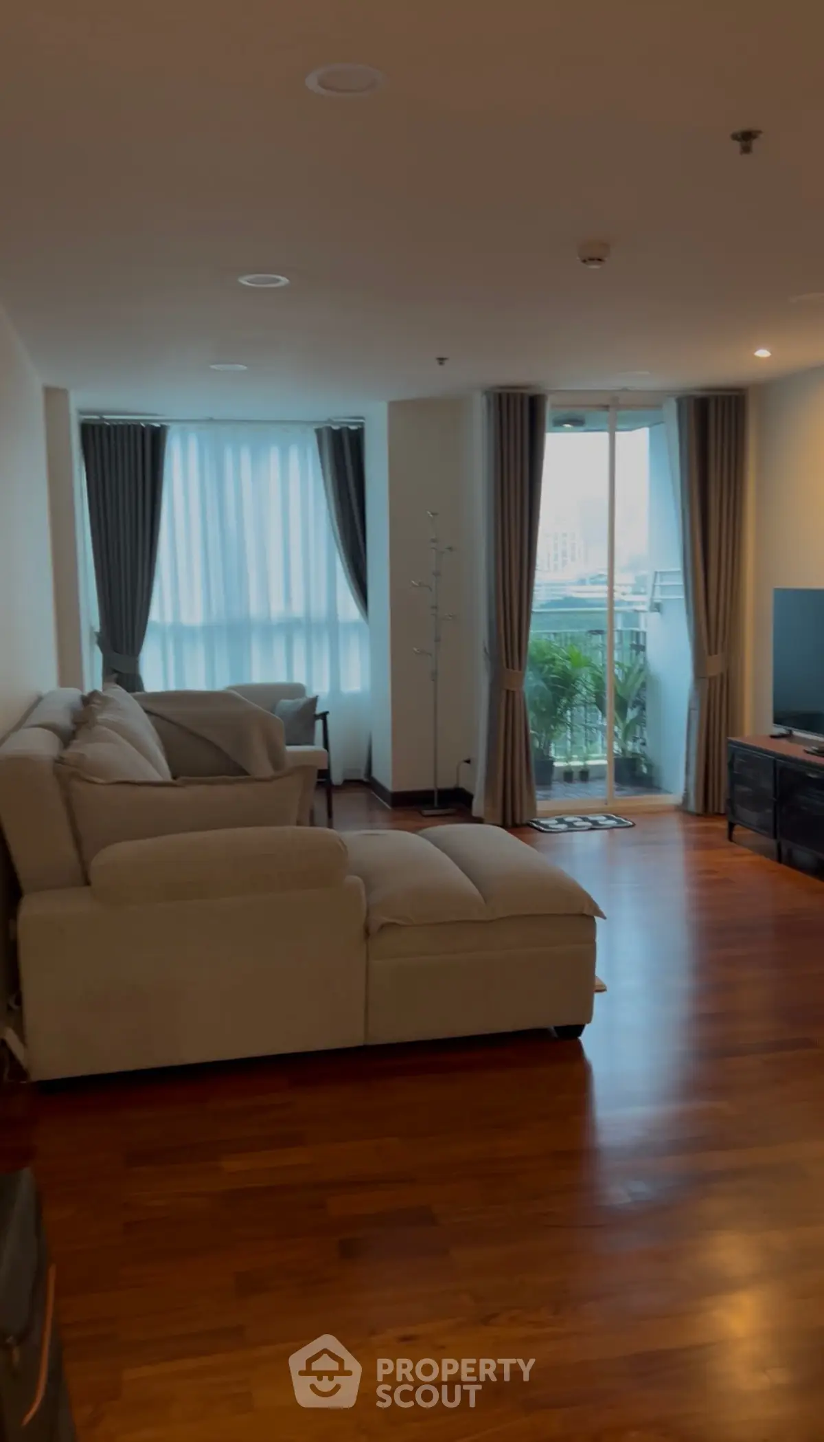 Spacious living room with modern decor and large windows offering a stunning view.