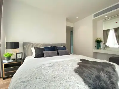 Luxurious bedroom with plush bedding and elegant decor in modern apartment