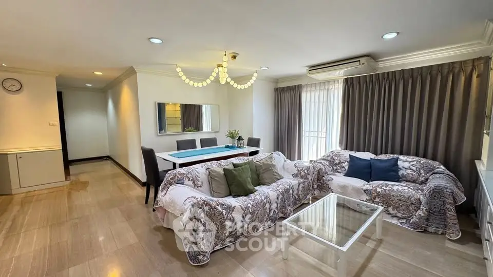 Spacious living room with elegant decor and ample natural light in a modern apartment.