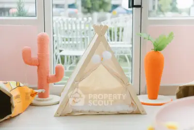 Charming pet-friendly interior with playful decor and cozy tent near large windows.