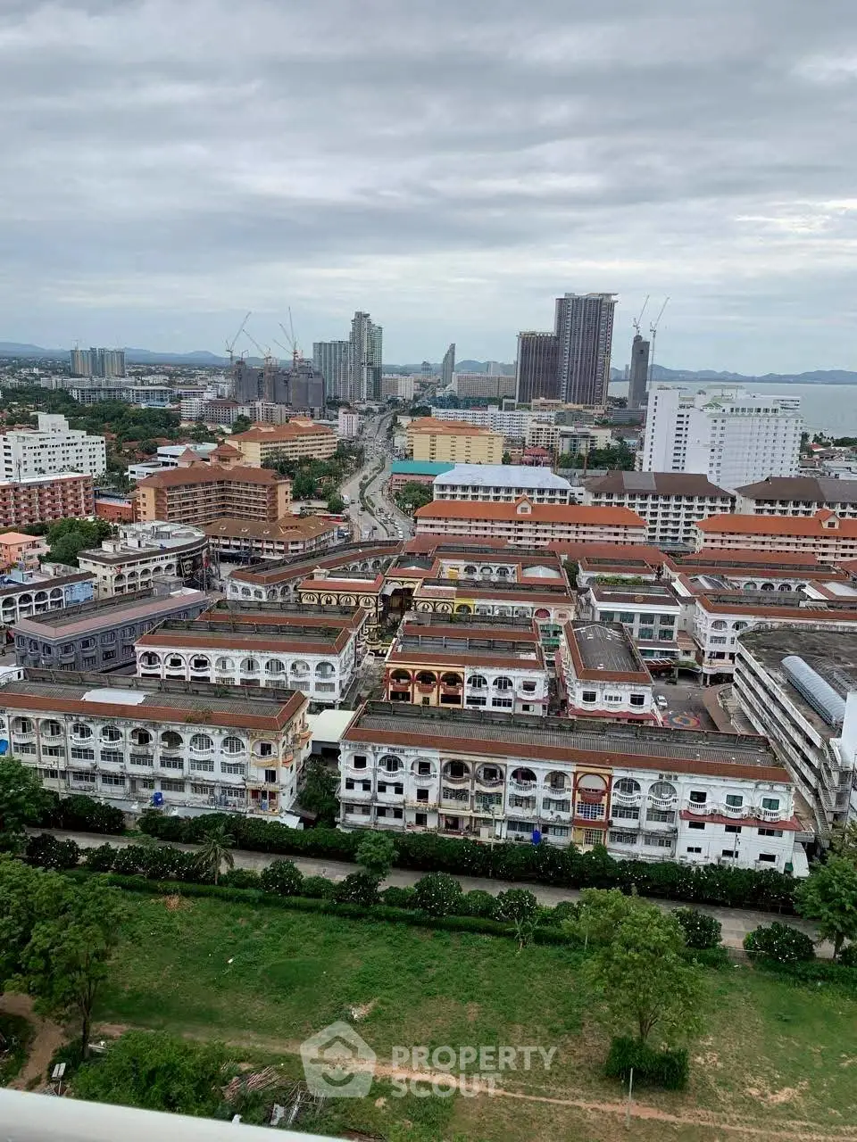 Stunning cityscape view showcasing urban architecture and skyline under a cloudy sky.