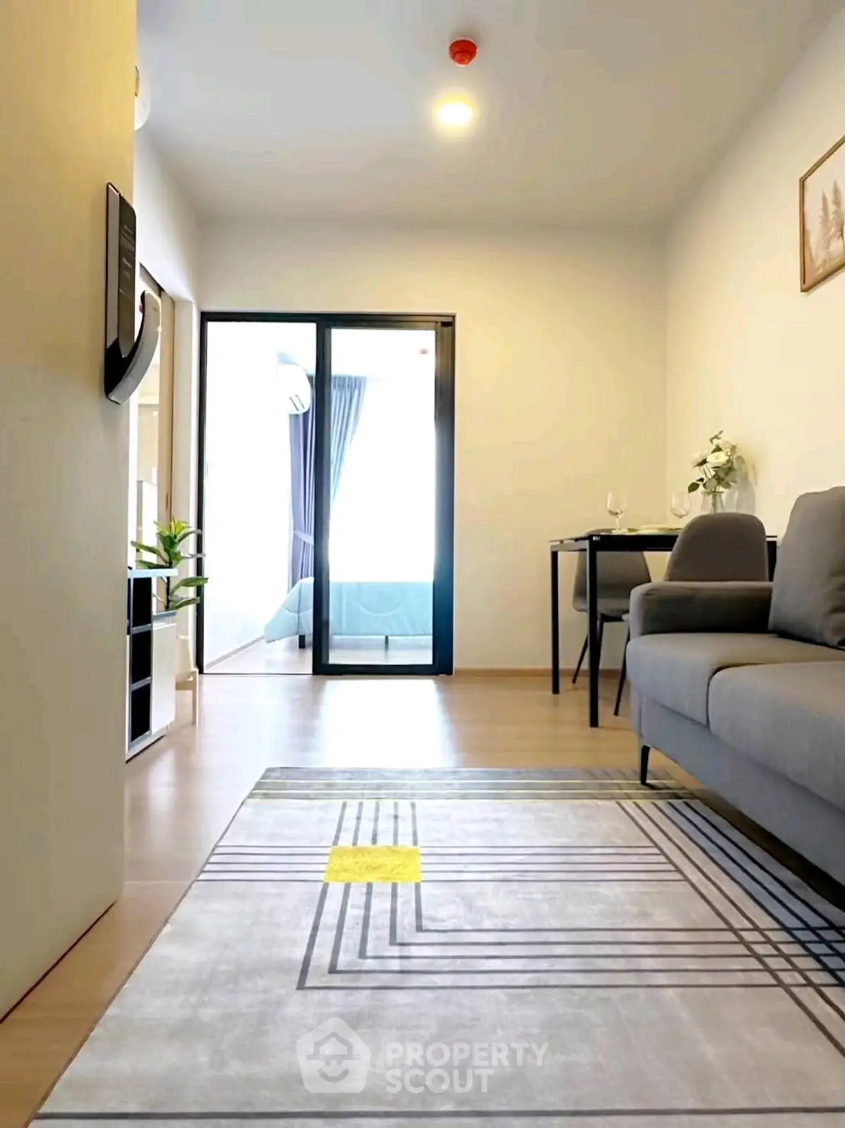 Modern living room with stylish decor and natural light in a contemporary apartment.