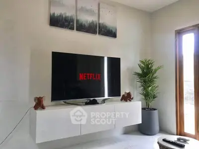 Modern living room with wall-mounted TV and stylish decor