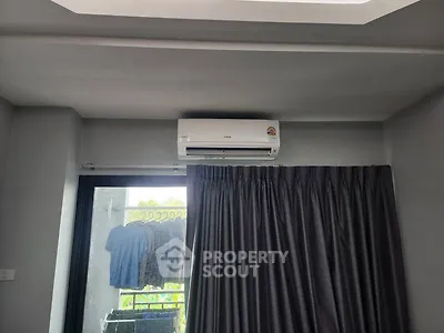 Modern living room with air conditioning and balcony view