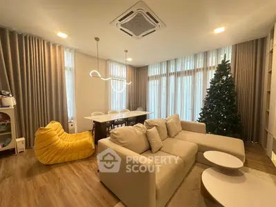 Modern living room with cozy sofa, dining table, and elegant lighting