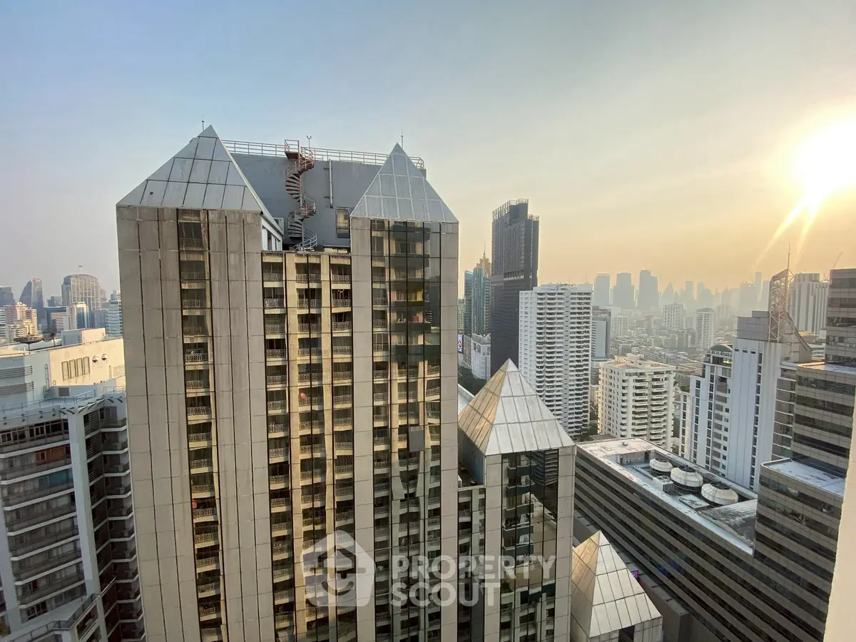 Stunning cityscape view from a high-rise building at sunset, showcasing modern architecture and urban skyline.