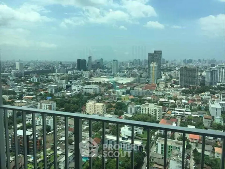 Stunning cityscape view from high-rise balcony overlooking urban skyline.