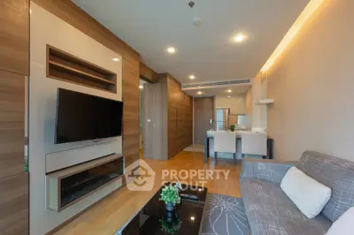 Modern living room with wooden accents and open kitchen layout