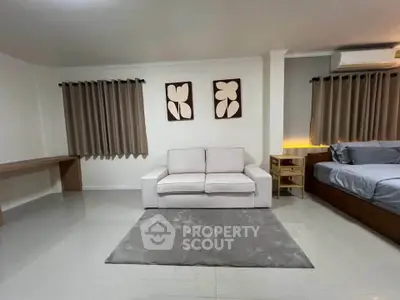 Modern living room with cozy sofa and stylish decor in a spacious apartment.
